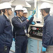 Laboratory technicians looking at sample in a lab.