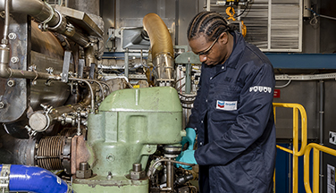 Chevron Oronite worker in marine test engine laboratory.